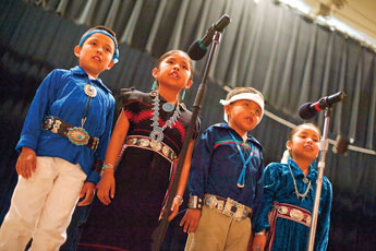 Twin Lakes first-graders (from left) Nicholas Yazzie, Alliyah Yazzie, Jimmy Chavez and Farrah Barney recite a traditional child's prayer in Navajo during the Navajo Language Cultural Festival at Red Rock Park Tuesday. © 2011 Gallup Independent / Brian Leddy